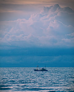 boat at sea during cloudy sky