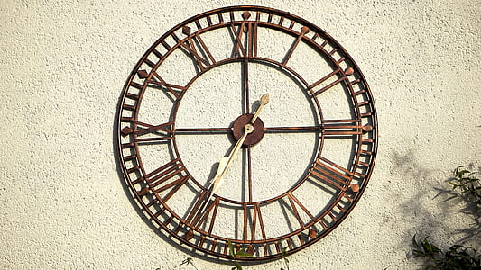 brown metal analog wall clock at 7:35