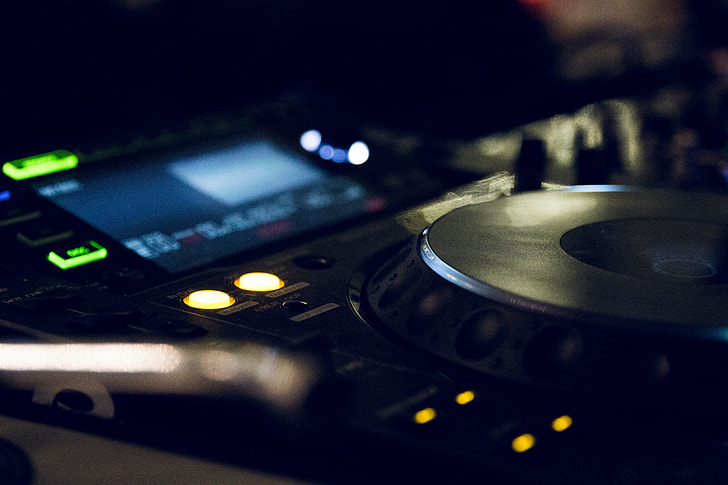 selective focus photography of turned on DJ controller
