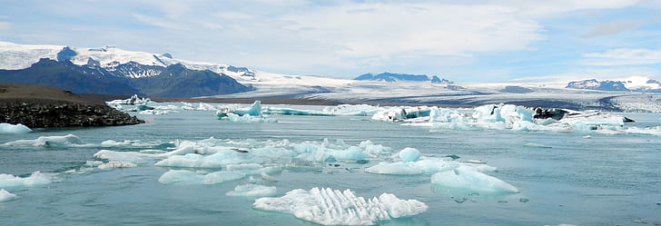 icebergs near mountains during daytime