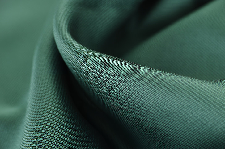 green textile close-up photography