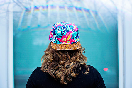 woman wearing floral cap facing back