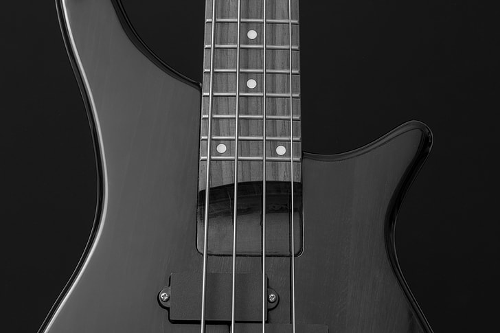 close up photography of black 4-string bass guitar