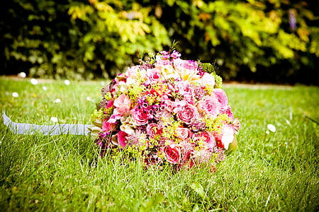 pink, red, and yellow flower bouquets on green grass
