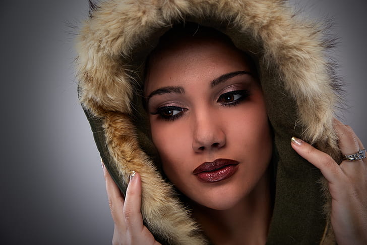 woman with full makeup wearing brown fur cap