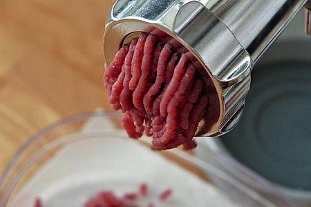 meat in gray metal grinder