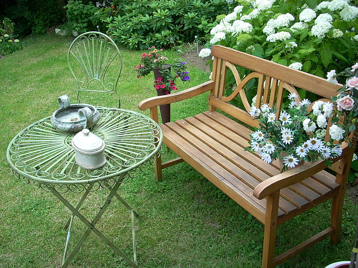 brown wooden bench and white metal patio set