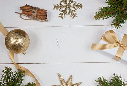 flat lay photography of gold Christmas baubles and gift box