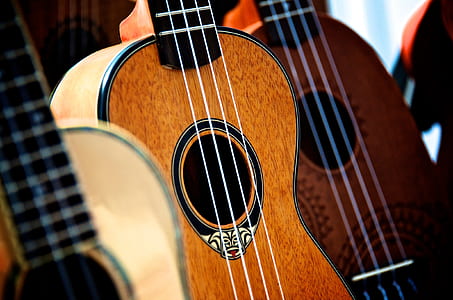 three brown and black ukuleles