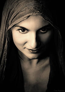 photo of woman in gray headscarf and black top