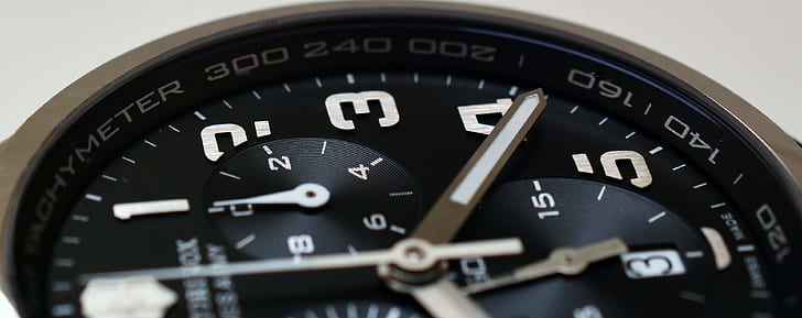 closeup photo of round black chronograph watch