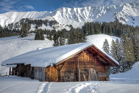 landscape photography of house near mountain filled with snow