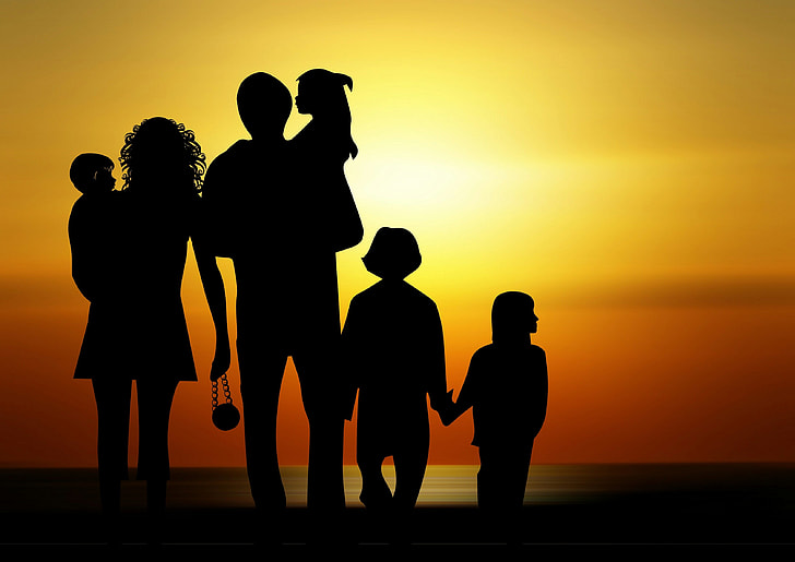 silhouette photo of family during sunrise