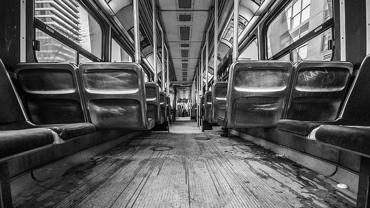 grayscale photo of seats inside train