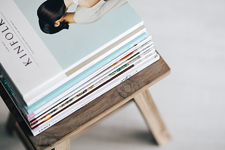 Stack of magazines on the wooden stool