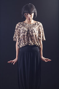 woman wearing brown floral blouse and black skirt