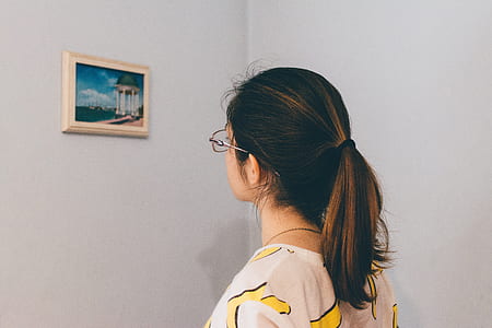 woman looking at picture on wall
