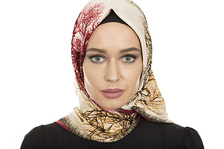 woman wears brown and red hijab headdress