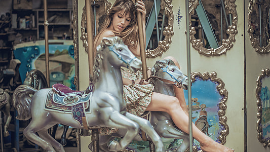 woman riding on a carousel
