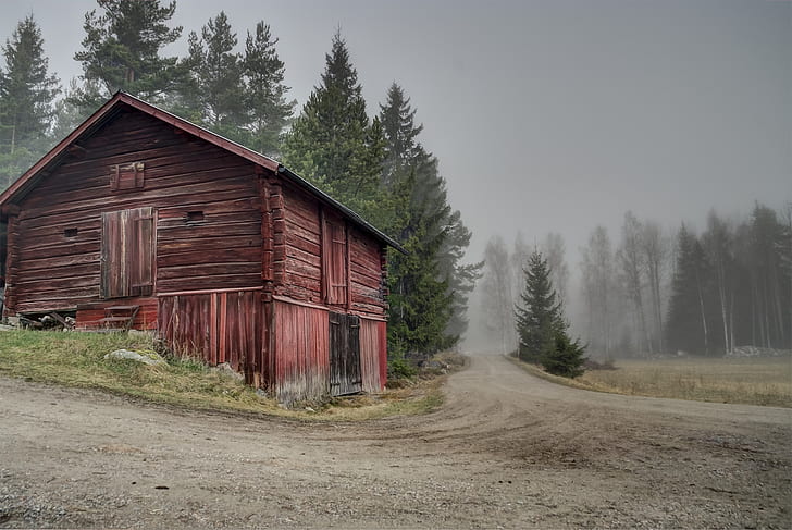 red wooden barn along road at daytime