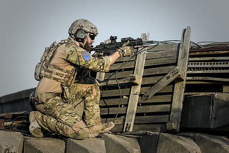 soldier holding black sniper rifle