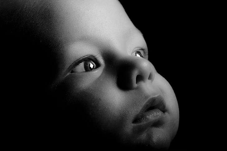 baby's face in grayscale photography