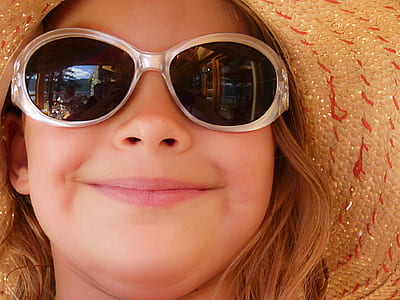 girl wearing sunglasses and brown hat