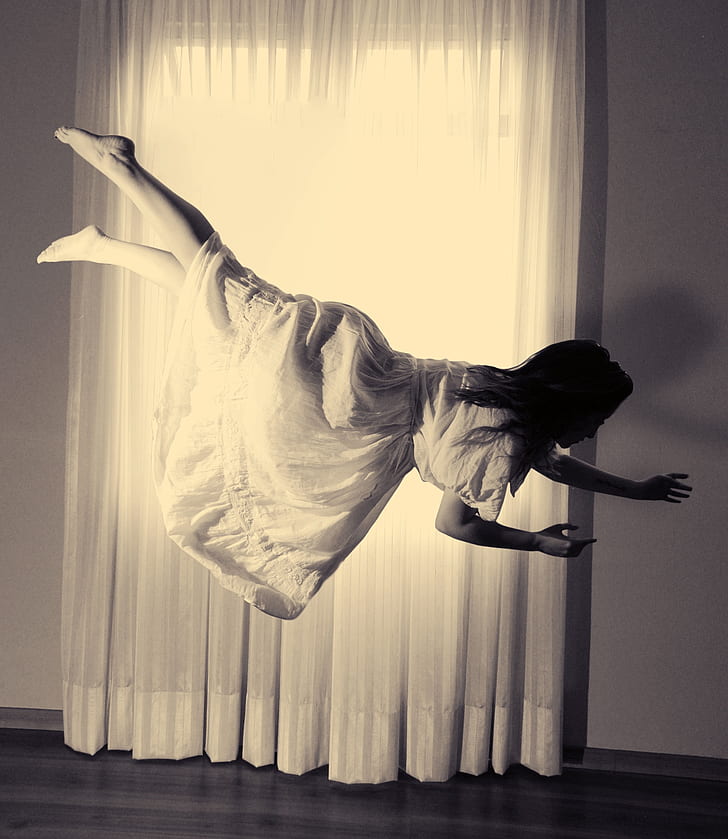 woman wearing white dress floating in the air