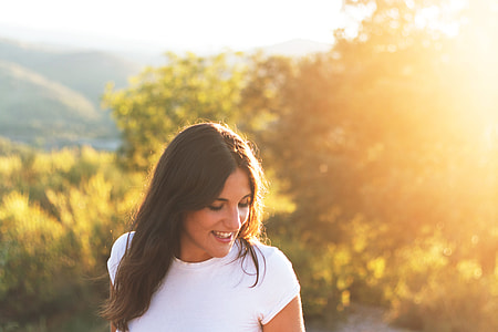 A girl with a smile dressed in a white t-shirt