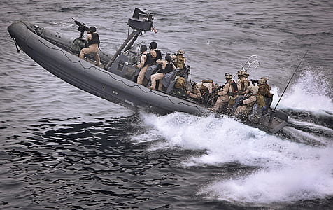 navy army on gray power boat