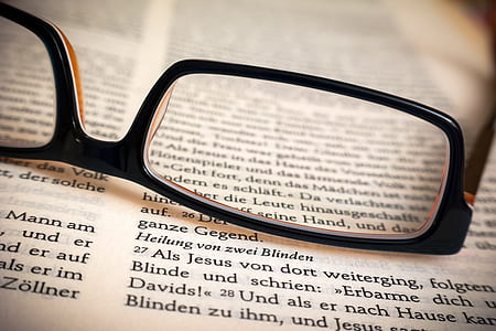 black frame eyeglasses on book top