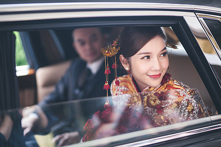 woman with traditional clothes in car
