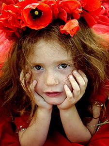 photo of a girl with red flowers