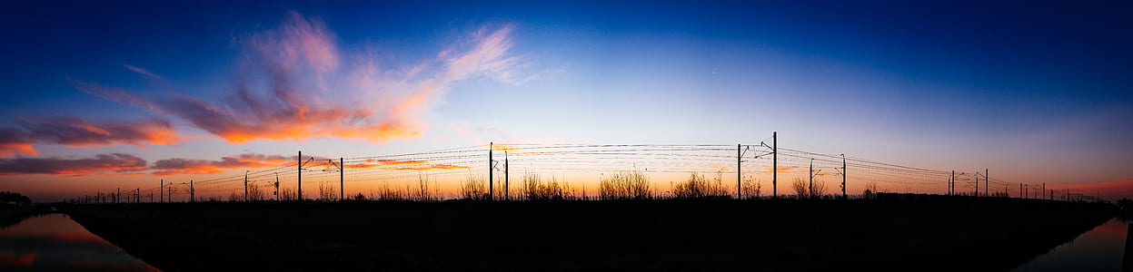 Silhouette of Street Post Light and Grass Under White Cloud and Blue Sky at Daytime