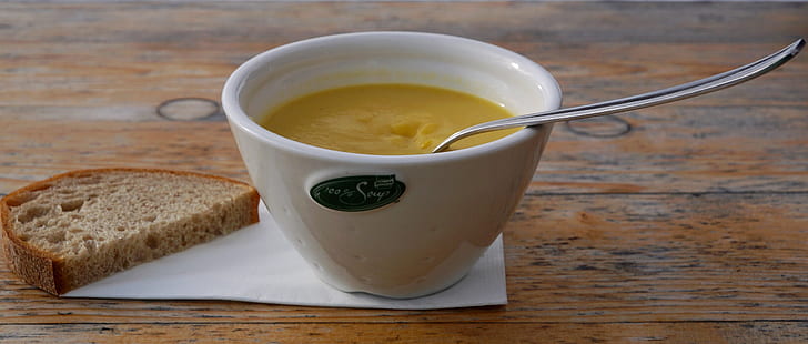 photo of white ceramic bowl of soup and bread