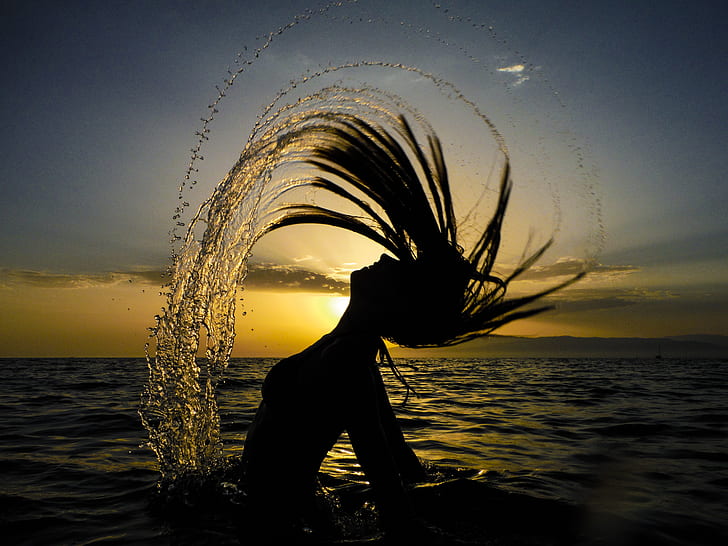 silhouette of a woman in body of water