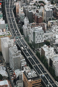grey concrete road between high rise buildings