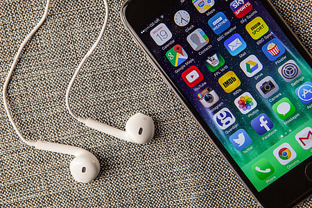Close up shot of the mobile iPhone 6 smartphone and Apple earphones