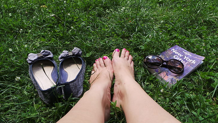 person's feet beside flat shoes