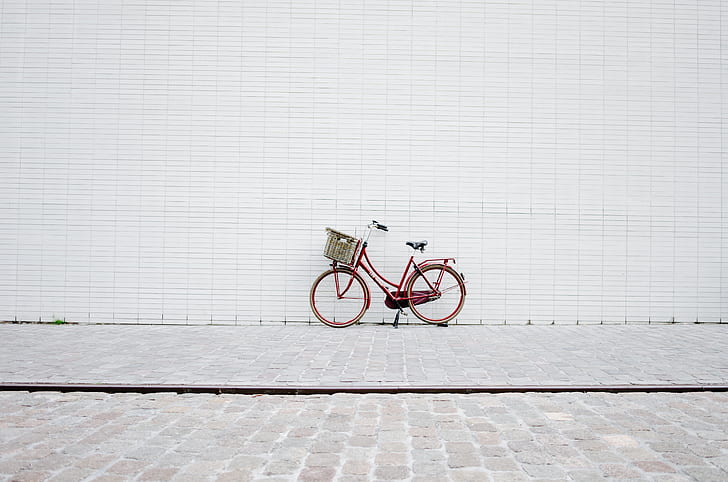 red bicycle on brick floor