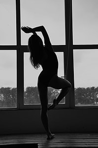 woman wearing monokini standing near window