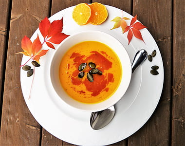 yellow soup on ceramic bowl