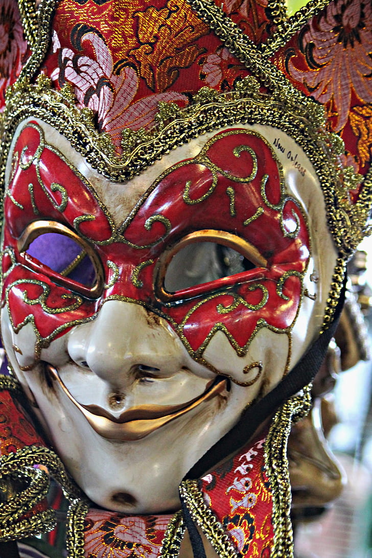 shallow focus photography of red and white venetian mask