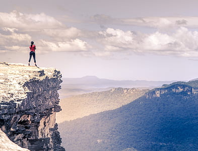 woman standing on top of mountain