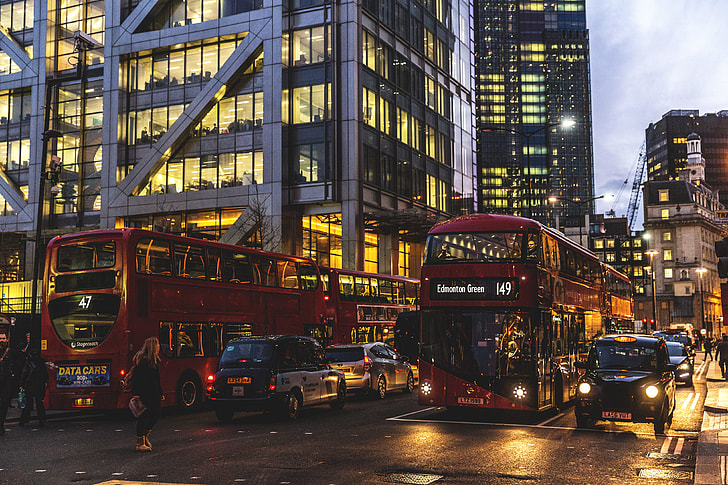 Traffic of taxis, buses and cars on the streets of London at sunset
