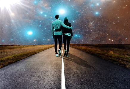 man and woman holding each other's arm walking towards road
