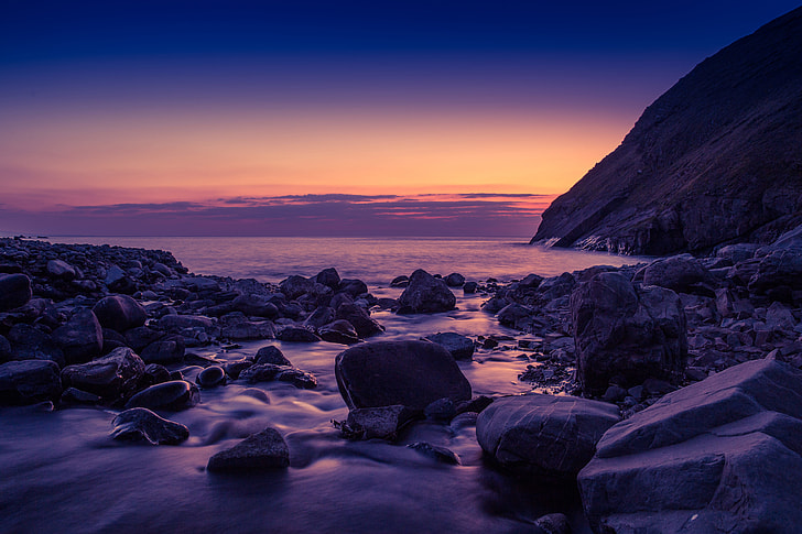 Sunset on a rocky beach in Cornwall, England