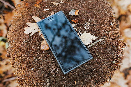 Black mobile phone on the ground