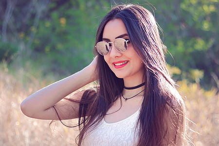 woman wearing white tank top and sunglasses selected focus photography
