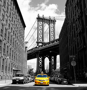 selective color of yellow car between buildings